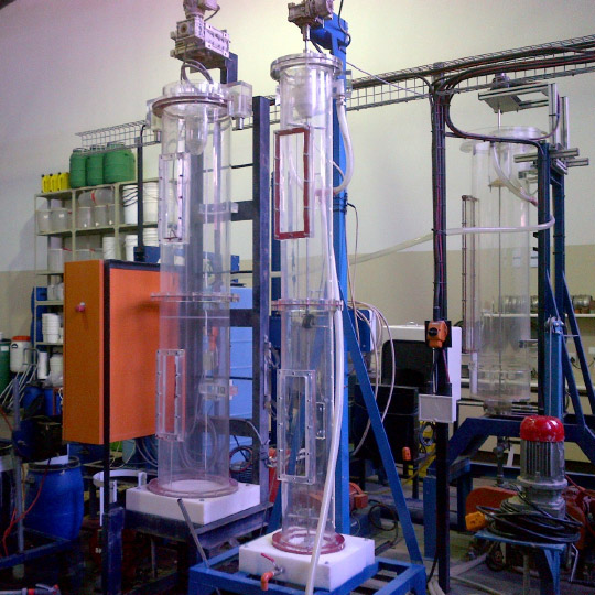 Semi-pilot scale Perspex thickeners with picket rakes for simulating paste thickening conditions in laboratory environment. Used for test work to generate design data for thickener sizing and optimisation including flocculant type selection, flocculant dose determination and feed-well dilution requirements. Further mud bed consolidation behaviour of the material in the thickener is investigated to determine thickener residence time and estimates of underflow density and overflow clarity. Laboratory facility in South Africa.